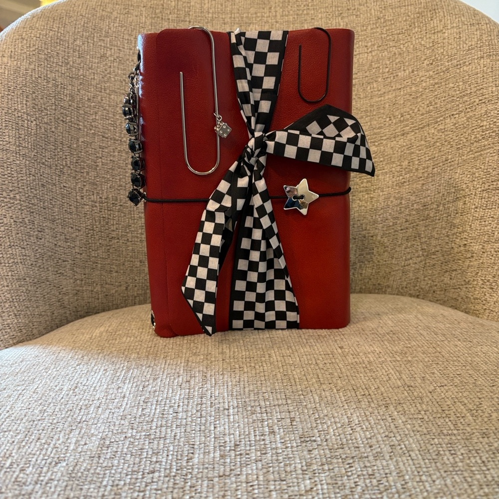 Red Leather chunky journal with added charms and clips and checkered tie.
